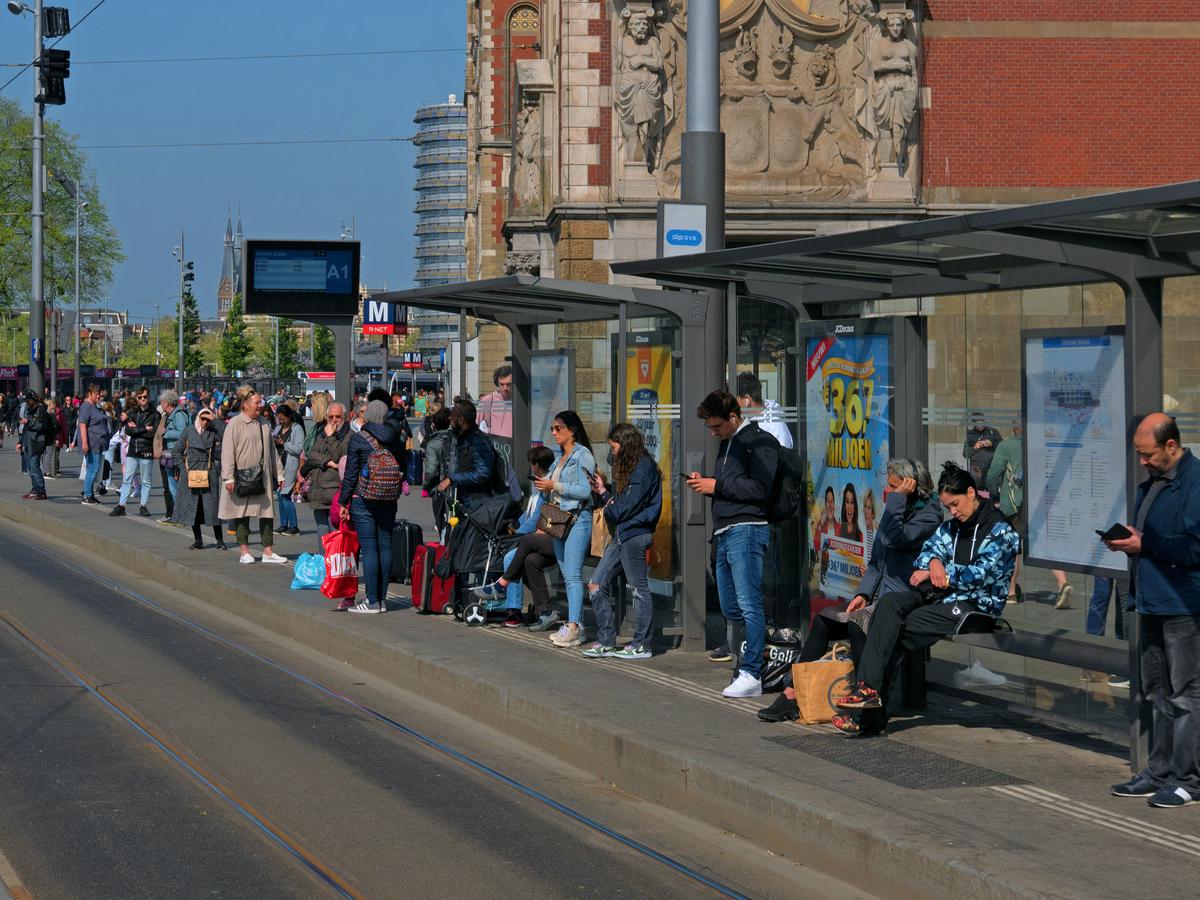 A group of people waiting for a bus, showcasing the bus rental industry and the importance of meeting customer expectations.
